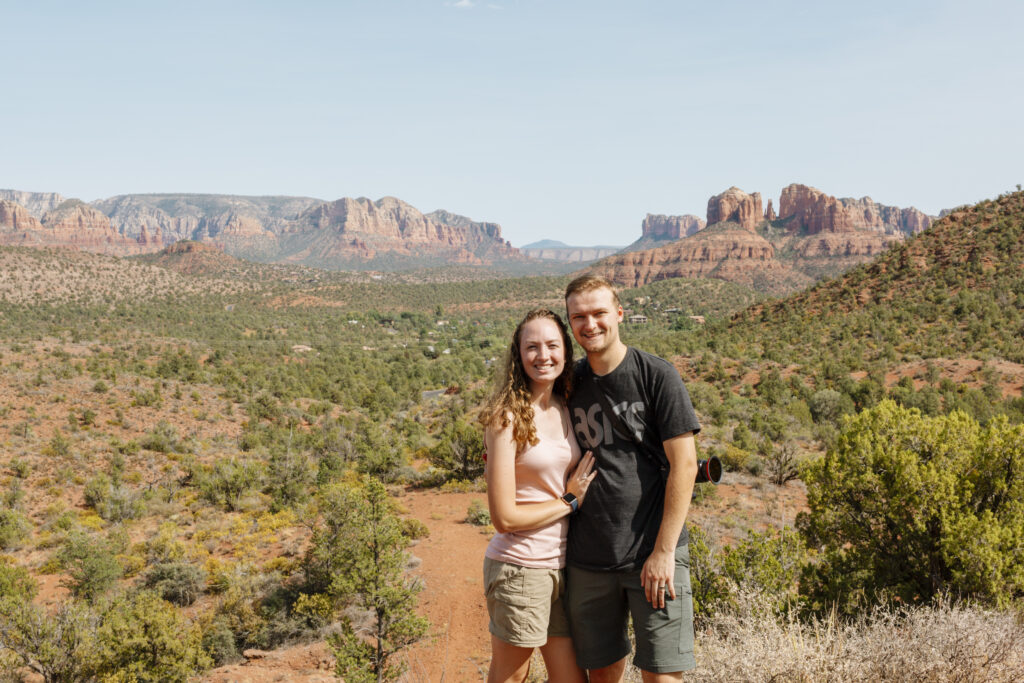 couple standing in front of red rocks arizona